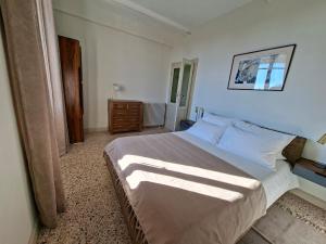 a bedroom with a large bed in a room at Villa Grappoli Apt MAGGIORE with lake view in Lesa