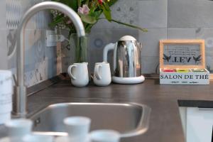 a kitchen counter with a sink and a silver tea kettle at Mellos B&B in Naples +63 photos