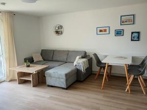 a living room with a couch and a table at little lake Faakersee in Faak am See
