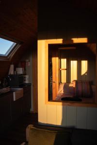 a mirror in a room with a bed and a kitchen at Skylark - Pod in Northrepps