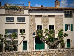 a white building with trees in front of it at Origines in Tautavel