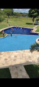 a group of people swimming in a large swimming pool at Day Use in Cascavel