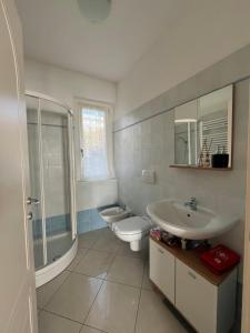 a bathroom with a sink and a toilet and a shower at Casa Ilaria in Armeno +62 photos