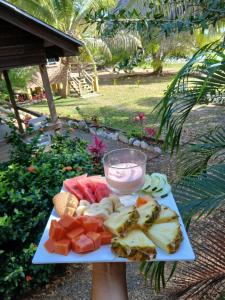 a plate of food with a drink on a table at CROOКED TREE LODGE Belize in Crooked Tree