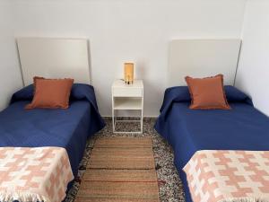 a room with two beds and a side table at Mediterranean House in Valencia in Valencia +43 photos