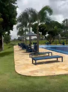 a row of blue benches next to a pool at Day Use in Cascavel +1 photo