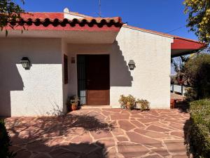 a white building with a door and a stone driveway at Mediterranean House in Valencia in Valencia