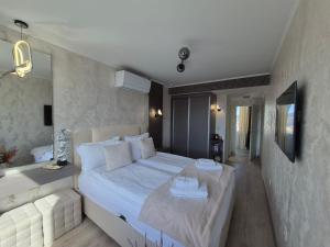 a bedroom with a large white bed in a room at The View -Balkan Tower безплатно паркомясто in Gabrovo