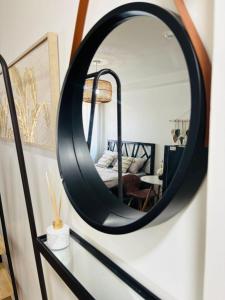 a mirror on a wall with a bed in a room at Urban Oasis Symphony Pool in Cebu City