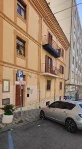 a car parked in a parking lot in front of a building at Casa Vacanze Cesarina - Catanzaro centro in Catanzaro