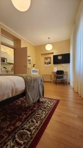 a bedroom with a bed and a living room with a table at Casa Vacanze Cesarina - Catanzaro centro in Catanzaro
