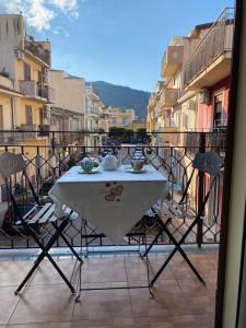 a table and chairs sitting on a balcony at Casa Doppia G in Oliveri