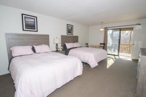 a bedroom with two beds and a balcony at Margarita Manor on Staniel Cay in Osage Beach +34 photos