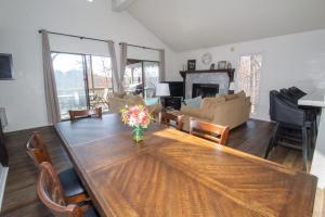 a living room with a wooden table and a couch at Margarita Manor on Staniel Cay in Osage Beach