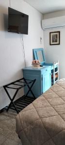 a bedroom with a desk with a tv and a bed at Casa Rosa in Taquisara