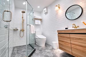 a bathroom with a shower and a toilet and a mirror at Greenfield Villa in Fengping +49 photos