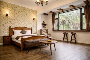 a bedroom with a bed and a chair and a table at Greenfield Villa in Fengping
