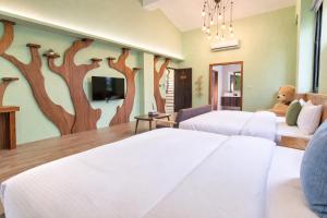 a hotel room with two beds and a teddy bear at Greenfield Villa in Fengping