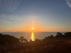 a sunset over the ocean from a building at Marina Elite Capo D'Arco in Capo D'Arco