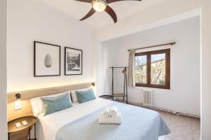 a bedroom with a bed and a ceiling fan at Hostal Nadal in Sóller