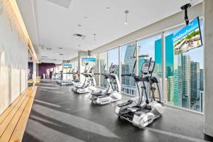 a gym with treadmills and elliptical machines at Downtown Miami Condo with Balcony & Rooftop Pool in Miami
