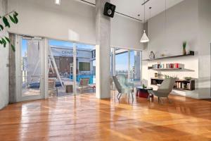 an open living room with a table and chairs at Downtown Miami Condo with Balcony & Rooftop Pool in Miami