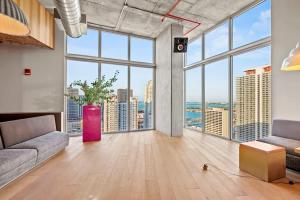 a large living room with a large floor to ceiling window at Downtown Miami Condo with Balcony & Rooftop Pool in Miami