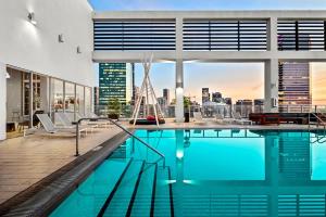a swimming pool on top of a building with a city skyline at Downtown Miami Condo with Balcony & Rooftop Pool in Miami +67 photos