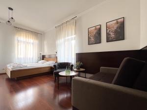 a living room with a bed and a couch at Willa 654 in Szklarska Poręba