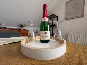 a bottle of wine is in a container on a table at Ferienwohnung Glücksklee in Tharandt