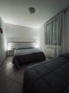 a bedroom with two beds and a window at Il Girasole in Campi Bisenzio +10 photos
