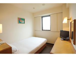 a hotel room with a bed and a television at Smile Hotel Towada in Towada +21 photos