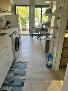 a kitchen with a washer and dryer on a tile floor at Casa ART residenza Bouganville in Costa de Antigua