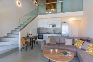 a living room with a couch and a table at MyPanormo Suites - Philip in Panormos Rethymno