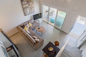 an overhead view of a living room with a couch and a table at MyPanormo Suites - Philip in Panormos Rethymno