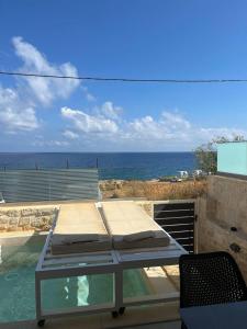 a glass table with a view of the ocean at MyPanormo Suites - Philip in Panormos Rethymno