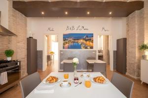 a table with croissants on it in a kitchen at Heart of Pescara Elegant Suites - Chic Suites in Pescara Center & 2 steps from Sea - AC & Wifi in Pescara