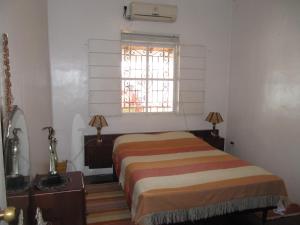a bedroom with a bed and a window at Casa Playas # 1 in Playas