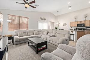 a living room with a couch and a table at Pet-Friendly 4BR Oasis - Heated Pool Firepit & BBQ in Chandler