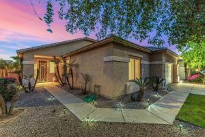 a home in a subdivision with a house at Pet-Friendly 4BR Oasis - Heated Pool Firepit & BBQ in Chandler