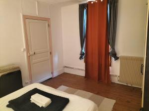 a room with a bed and a window and a door at l'oasis de paix in Dijon +13 photos