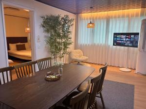 a dining room with a table and chairs and a bedroom at Coco House in Daejeon