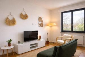 a living room with a flat screen tv and a couch at LaBohème Lake Maggiore Retreat with Private Beach in Dormelletto