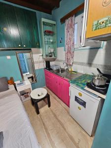 a small kitchen with a sink and a stove at CaN-CaN in Mikonos