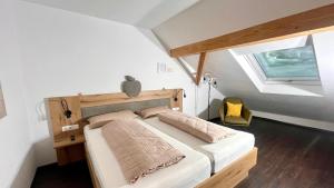 a bedroom with a bed with a wooden headboard and a window at Apfel-Stadl "Gala", Oberreute in Oberreute