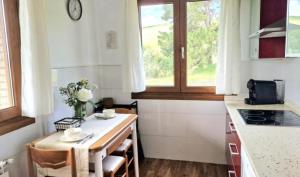 a small kitchen with a small table and a window at Villa Galana Oyambre in Los Llaós +13 photos