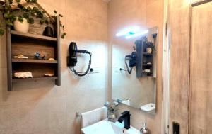 a bathroom with a sink and a mirror at Villa Galana Oyambre in Los Llaós