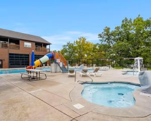 a swimming pool with a slide and a playground at On the Rocks Lodge in Branson