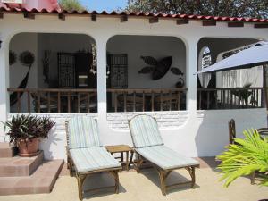 a pair of chairs sitting on a patio at Casa Playas # 1 in Playas