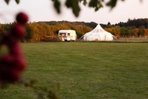 a tent and a trailer in a field at Stargazer Bell Tent in Northrepps